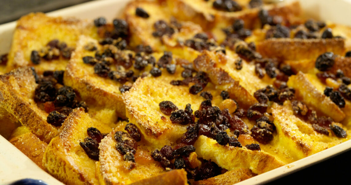 Delicious traditional Bread and Butter pudding with egg custard sugar and dried fruits.  Shallow dof.